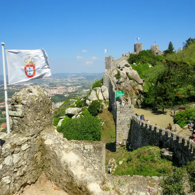 The Portuguese flag on the ramparts of the Moorish Castle with the wall walk beyond