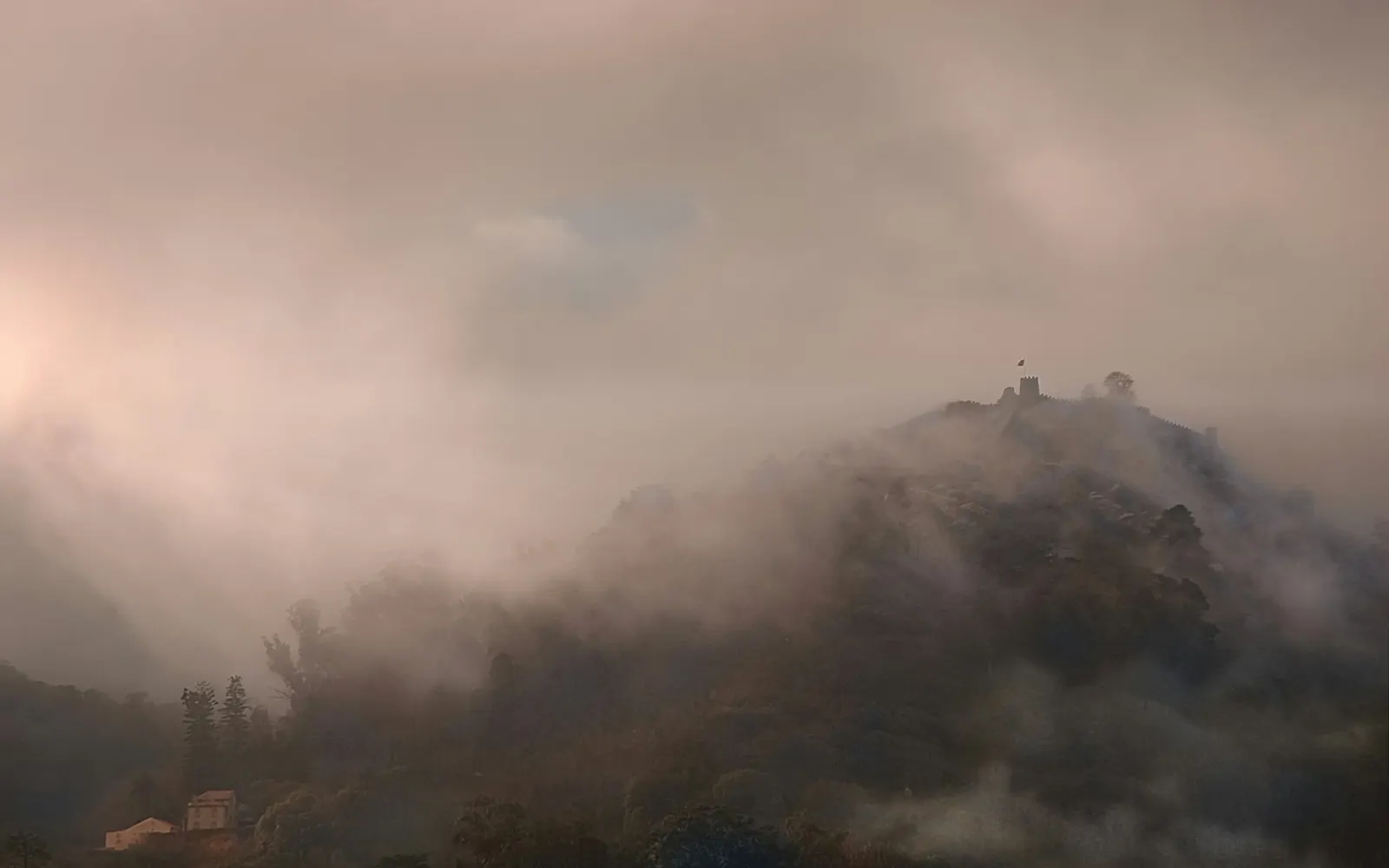 The Castelo dos Mouros emerging from morning mist on the Sintra ridge